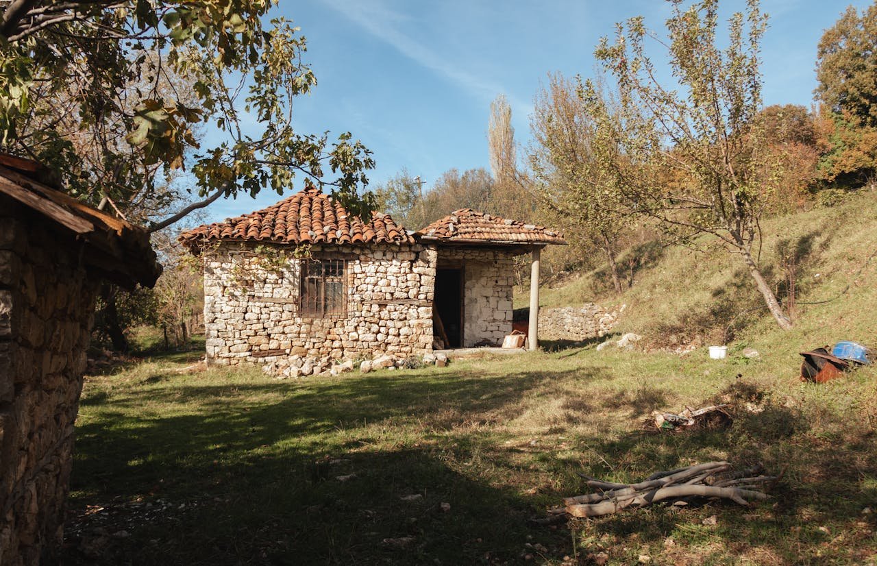 Offerings Charming stone cottage surrounded by nature in rural Tirana, showcasing traditional architecture.