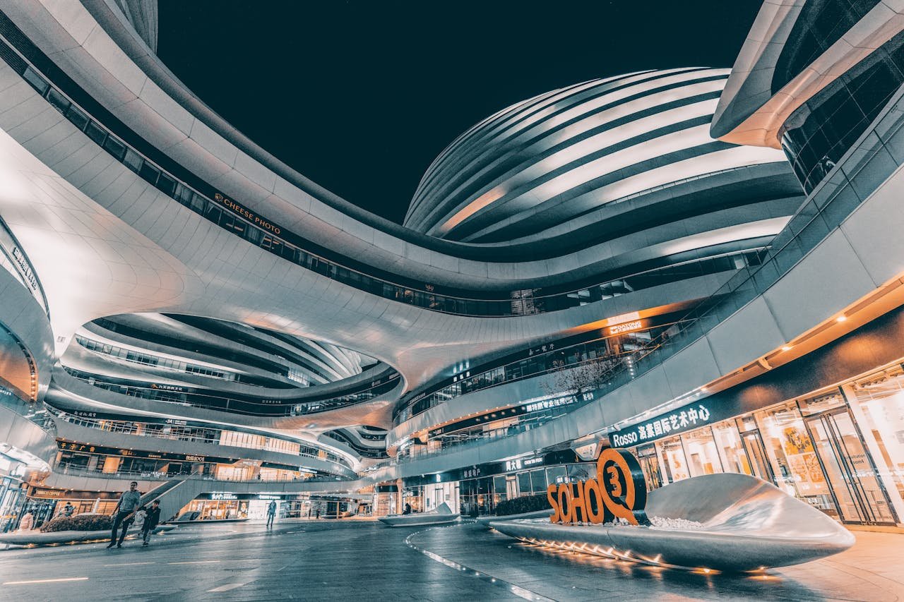 Night view of the modern architectural landmark Galaxy Soho in Beijing, China, showcasing futuristic design.